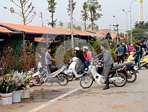 Asian man buying flowers in the market