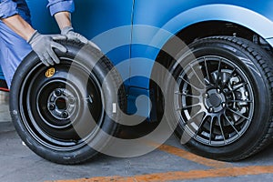 Asian man car inspection Measure quantity Inflated Rubber tires car.Closeup hand holding