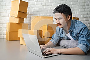 Asian man Checking order on laptop,heâ€™s working at home,start up business concept