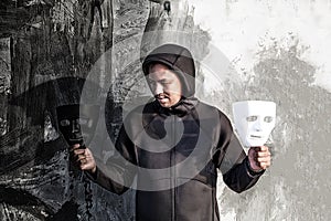 Asian man chooses between black and white mask in scary abandoned building, Human face expression, Good and Bad temptation