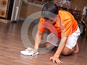 Asian man cleaning floor
