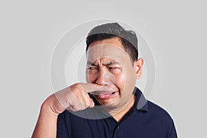 Asian Man Close His Nose Sick of Bad Smell