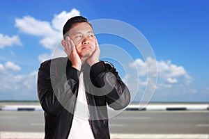 Asian Man Closing His Ears