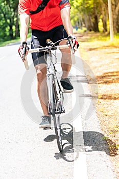 Asian man cycle in countryside road, close up