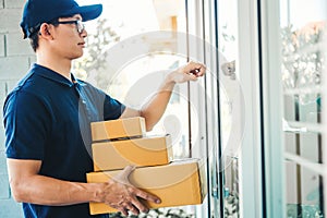 Asian man Delivery service courier Knock the door house with boxes in hands
