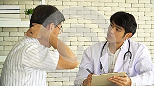 Asian man doctor asking health problems patient questions and taking notes