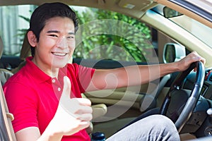 Asian man driving car