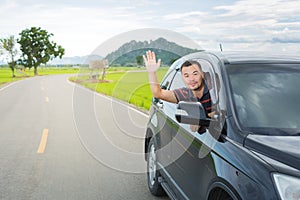 Asian man driving car