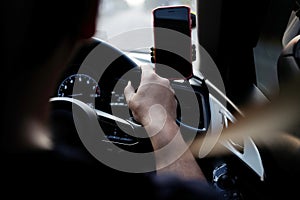 Asian man driving car and hand is holding steering wheel