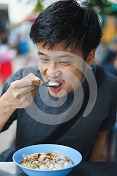 Asian man eating congree photo