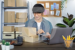 Asian man entrepreneur startup small business entrepreneur SME freelance man working with box to online marketing packaging and