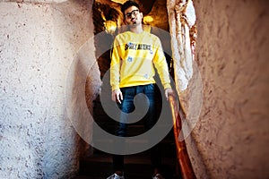 Asian man in eyewear and yellow sweatshirt .