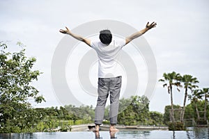 Asian men feel refreshed with the sky and the atmosphere on the vacation. photo