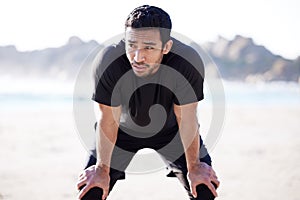 Asian man, fitness and exhausted with break at beach for sports, exercise and training for body health. Male athlete
