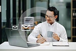 Asian man hands using Laptop, tablet typing on keyboard and surfing the internet with email icon, email marketing concept, send e-