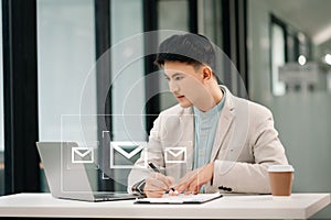 Asian man hands using Laptop, tablet typing on keyboard and surfing the internet with email icon, email marketing concept, send e-