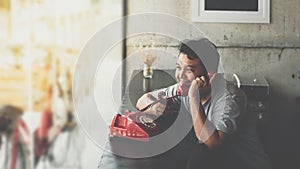 Asian man happy talk phone call in coffee shop