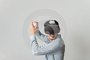 Asian man have fun with playing video game on VR goggles headset