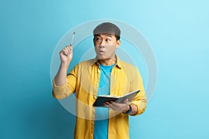 Asian Man Having Idea. Portrait of Inspired Handsome Man Pointing Pencil Up