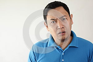 Asian Man Having Skeptical and Dissatisfied or Distrust Expression