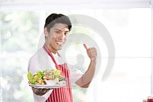 Asian man held a salad plate for the camera