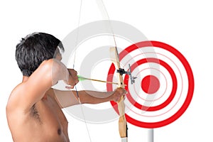 Asian man holding bow and shooting to archery target.