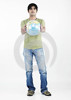 Asian man holding a globe