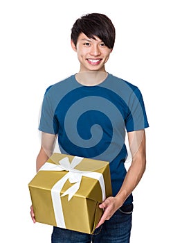 Asian man holding with golden big present box