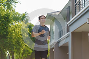Asian man are jogging in the neighborhood for daily health and well being, both physical and mental and simple antidote to daily