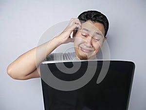 Asian Man Looked Regret and  Disappointed Expression Looking at Laptop
