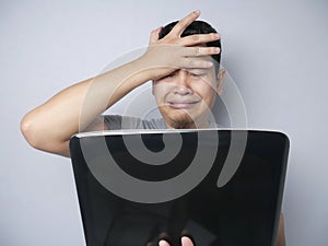 Asian Man Looked Regret and  Disappointed Expression Looking at Laptop