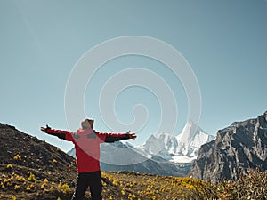 Asian man looking at Mount Yangmaiyong or Jampayang in Tibetan in Yading, China