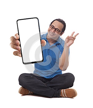 Asian man looking to camera, smiling and showing empty blank white copy space phone mock up template