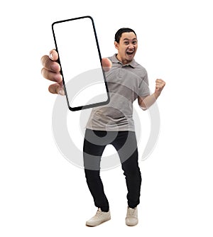 Asian man looking to camera, smiling and showing empty blank white copy space phone mock up template