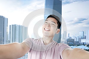 Asian man making selfie using the camera phone