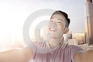 Asian man making selfie using the camera phone