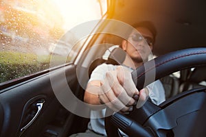 Asian man male ware sun glass drive a car.