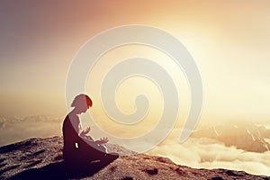 Asian man meditates in yoga position. Above clouds