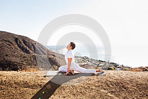 Asian man meditates in yoga position on high