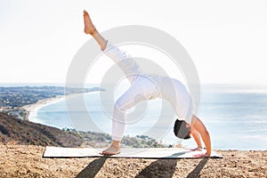 Asian man meditates in yoga position on high