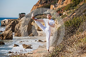 Asian man meditates in yoga position on high