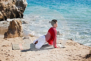 Asian man meditates in yoga position on high