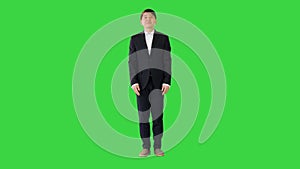 Asian man in office suit making a bow on a Green Screen, Chroma Key.