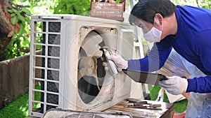 Asian man online learning and repair air conditioner at home. New normal and life after COVID. Lock down and Self-quarantine.