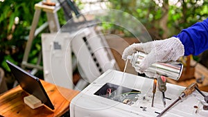 Asian man online learning and repair air conditioner at home. Social distancing and New normal