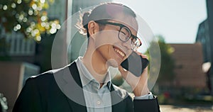 Asian man, phone call and laughing in city for funny joke, conversation or outdoor networking. Happy businessman smile