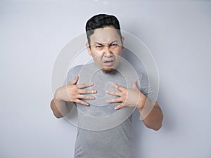 Asian Man Pointing Himself with Unhappy Expression as if he confused to be accused