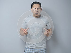 Asian Man Pointing Himself with Unhappy Expression as if he confused to be accused