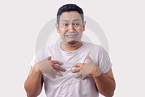 Asian Man Pointing Himself with Unhappy Expression as if he confused to be accused