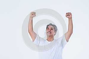 Asian man raised both hands above the head, showing joy and succeed